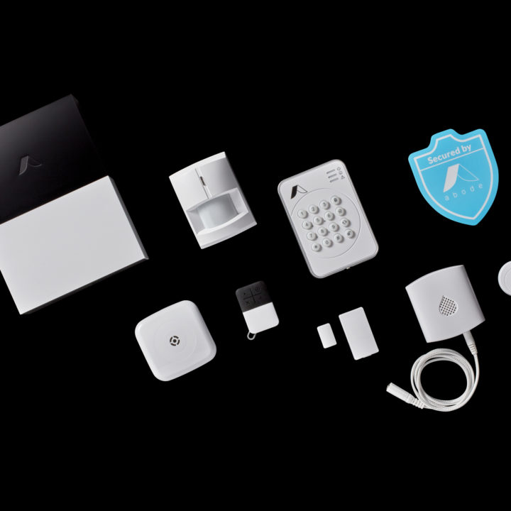 abode home security devices on a black background